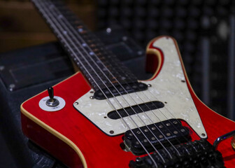 Fototapeta na wymiar red electric guitar on top of an amp