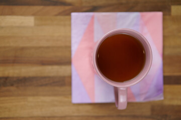 Above a tea cup on matching napkin, sitting on wooden table 5