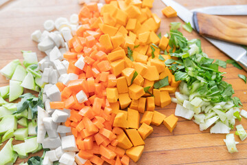 Chopped and prepared vegetables on kitchen board