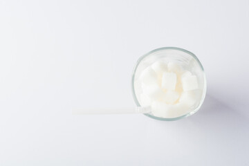 Top view glass full of white sugar cube sweet food ingredient