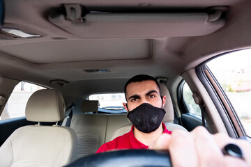 Arabic man driving his car with smile and feeling confident