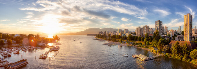 Obraz premium Aerial Panoramic View of Modern City with a beach on the West Coast Pacific Ocean. Sunny Summer Sunset. False Creek, Downtown Vancouver, British Columbia, Canada.