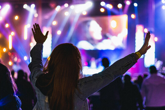 worship concert in a church woman raised hands