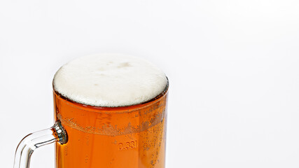 Mug of cold light beer on a white background. Beer foam and bubbles. Traditional light alcoholic drink shot. Close-up. Copy space