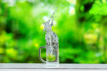 Fruits falling into the glass that sits on the bar.  water spread