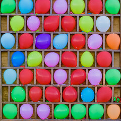Shooting gallery with bright colorful balloons in amusement park