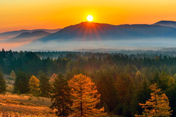 Magnificent sunrise over Mount Eseikey in the Ural Mountains, the beginning of an autumn day.