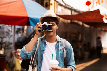 Photographer taking photos of lively streets with restaurants