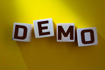 Demo symbol. Concept word 'demo' on cubes on a beautiful dark wooden background. Business and demo concept. Copy space.