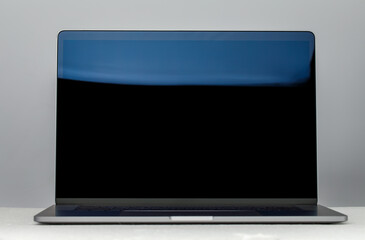 Hightech flat silver luxury notebook computer with lid open showing black screen. Display in isolated background