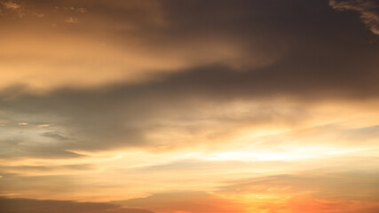 Background of orange sky and clouds with sunset light in evening at summer time when with blank copy space, showing about environment, climate concept.