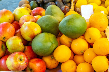 Apples, oranges and mangos for sale at a market