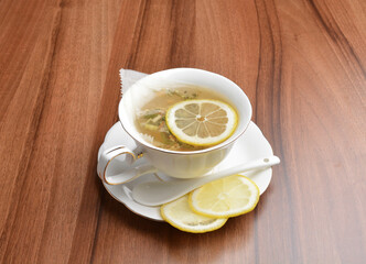 hot ginger lemon fruit tea bag drink in beautiful England design white cup hot healthy beverage menu