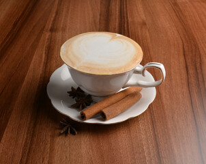 hot masala chai latte drink with cinnamon and star anise in beautiful England design white cup hot coffee beverage menu