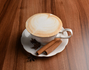 hot masala chai latte drink with cinnamon and star anise in beautiful England design white cup hot coffee beverage menu