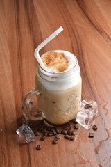 ice cafe mocha latte drink with bubbles and coffee bean in glass on wood table coffee beverage menu