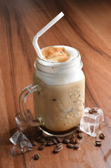 ice cafe mocha latte drink with bubbles and coffee bean in glass on wood table coffee beverage menu