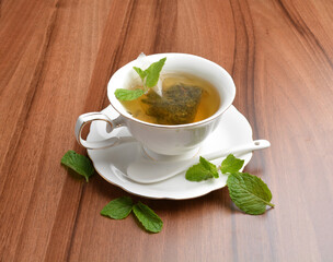 hot moroccan mint leaf tea bag drink in beautiful England design white cup hot healthy beverage menu