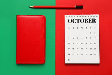 Flip paper calendar, pencil and notebook on color background