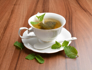hot moroccan mint leaf tea bag drink in beautiful England design white cup hot healthy beverage menu