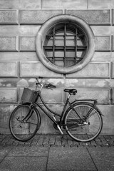 Vintage red bicycle on wall with round window background