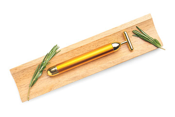 Board with facial massage tool and rosemary on white background