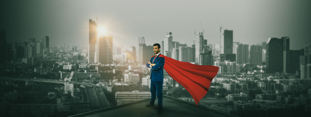 Businessman superhero  standing on building  rooftop to looking cityscape at night,concept...