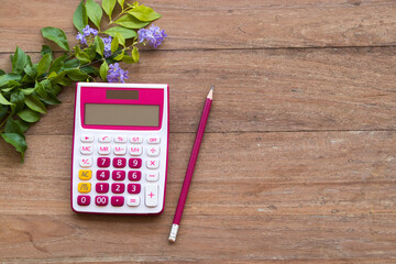calculator equipment for work account with purple flower arrangement flat lay style on background...