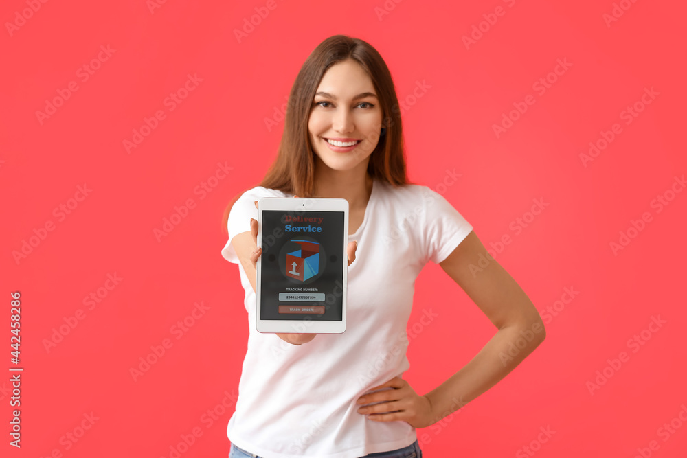 Poster young woman holding tablet computer with open page of delivery service application on color backgrou
