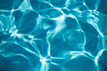 Background of blue water in swimming pool with sun reflection, ripple water wave in pool. Clear water background.