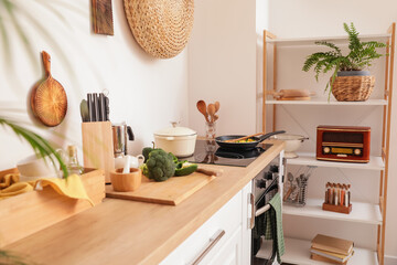 Modern electric stove and utensils in kitchen