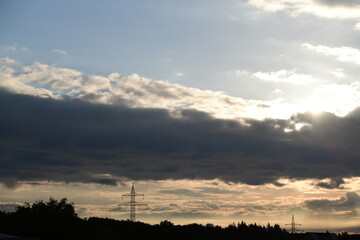 Beautiful dawn with a big dark cloud and the sun shining behind it