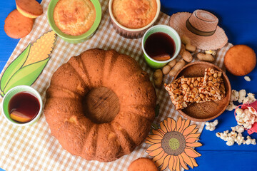 Traditional food for Festa Junina (June Festival) on color wooden background