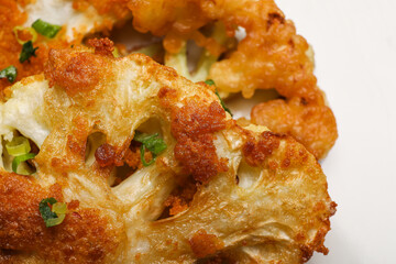 Tasty fried cauliflower on white background, closeup