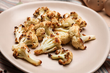 Plate with tasty fried cauliflower on table, closeup