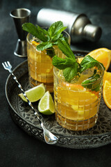 Glass of   lemonade  made of orange, lime and lemon on  tray