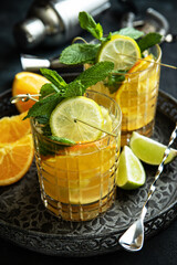 Glass of   lemonade  made of orange, lime and lemon on  tray
