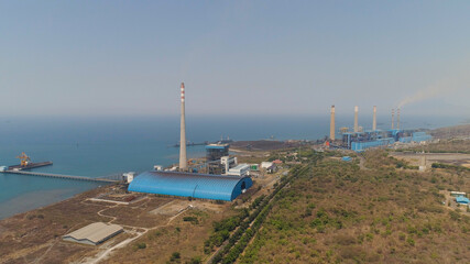 power station by sea with smoking pipes, paiton java, indonesia. aerial view power plant in asia.