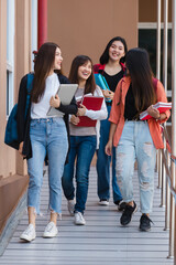 Group of young attractive asian girls college students walking together in university campus...