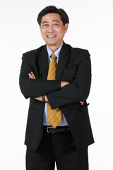 Obraz na płótnie Canvas Senior asian businessman standing with arms crossed. Take off glasses smile look at camera. Characters of success banker, businessman, lawyer. Gesture more relax and happy face.