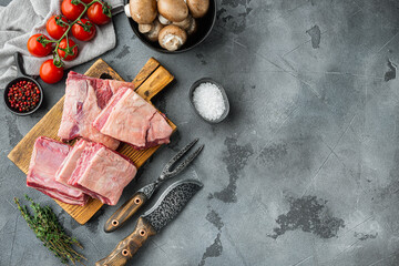 Short Ribs Bone In stew, with ingredients , on gray stone background, top view flat lay, with copy space for text