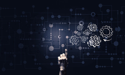 Glowing cogwheel mechanism icon on dark background as symbol of teamwork