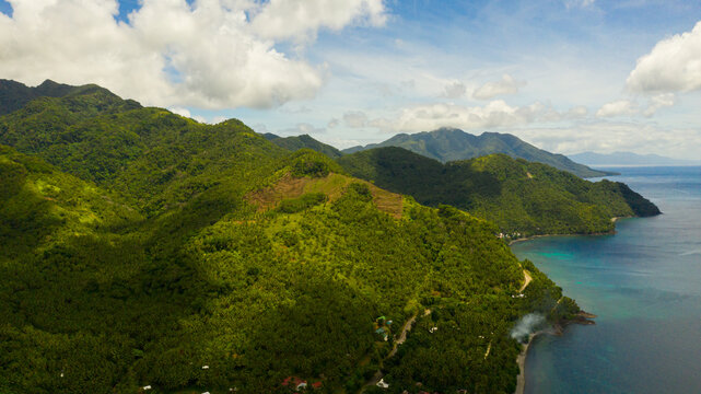 Aerial seascape: the coast of Leyte island with hills and mountains covered with green forest and jungle. Philippines.
