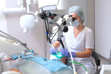 Dental treatment with a microscope.Modern dentistry. Accurate treatment of complex diseases.