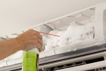 Fototapeta na wymiar air conditioner cleaning with spray foam cleaner