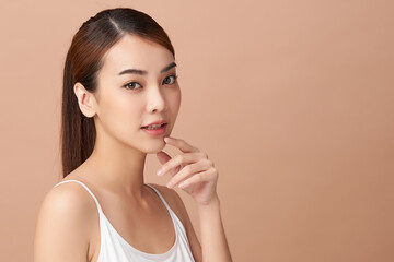 Beautiful young asian woman with clean fresh skin on beige background, Face care, Facial treatment, Cosmetology, beauty and spa, Asian women portrait.