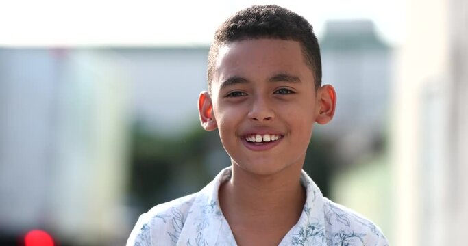 Brazilian little boy child smiling face close-up outside