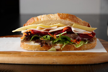 Healthy ham, cheese and salad sandwich on board