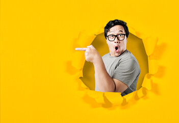 Asian man in eyeglasses pointing something with excited expression