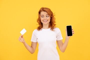 happy woman showing credit or debit card and smartphone to make online shopping, payment online.